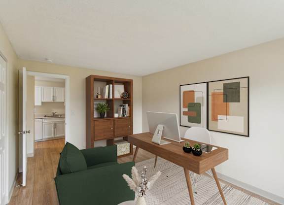 a living room with a desk with a computer and a green couch at North Stoughton Village, Massachusetts