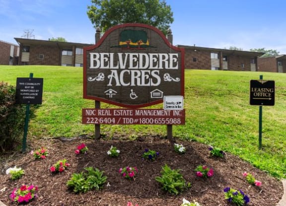 a sign in the middle of a grassy field  at Belvedere Acres Apartments, Washington, PA, 15301