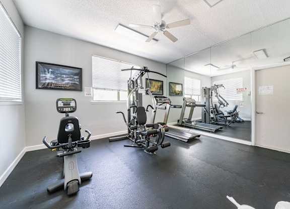 A spacious home gym with a variety of exercise equipment Fishermans Landing Apartments in Ormond Beach, FL.