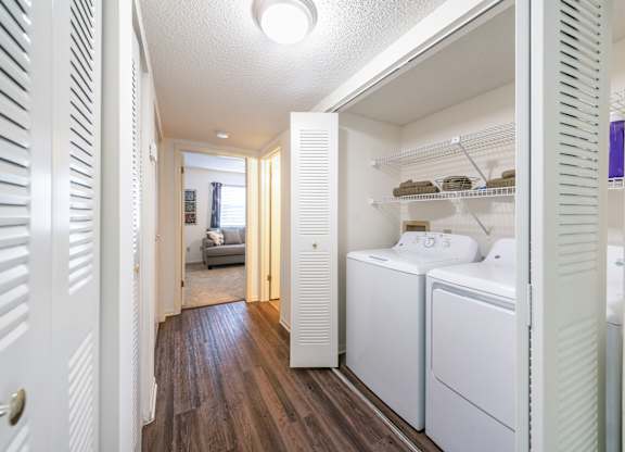A white laundry room with a washer and dryer Fishermans Landing Apartments in Ormond Beach, FL.