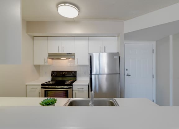 a kitchen with white counters and a stainless steel refrigerator at Ninth Square Apartments, New Haven, CT