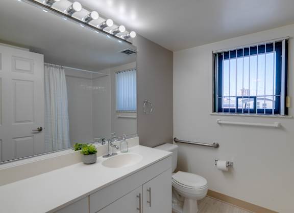 a bathroom with a sink and a toilet and a mirror at Ninth Square Apartments, Connecticut, 06510