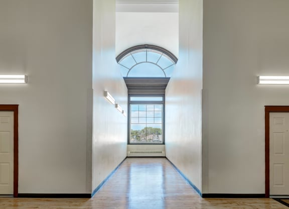a hallway with an arched ceiling and a window at Chapman House, E. Boston