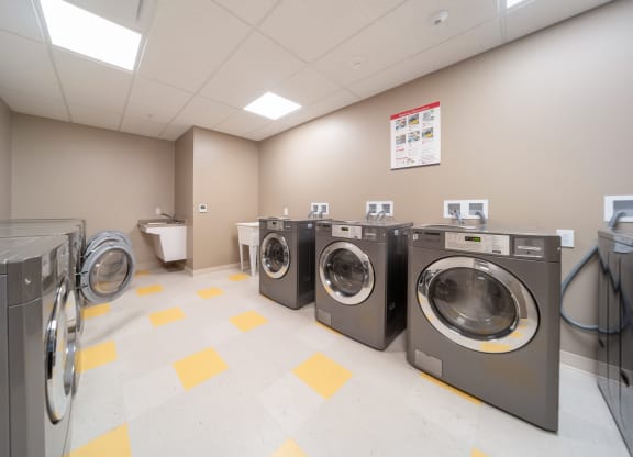 Community laundry room with washers and dryers at Richford Arms Apartments, Erie, PA