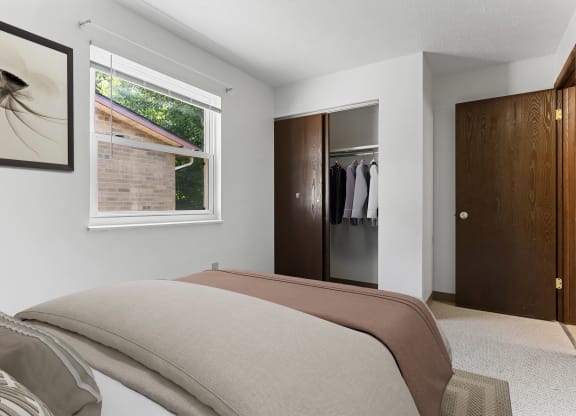a bedroom with a large bed and a large window at Huntingdon Village Apartments, Hunker, 15639