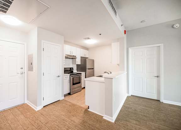 a renovated kitchen with white cabinets and stainless steel appliances at Ninth Square Apartments, Connecticut, 06510