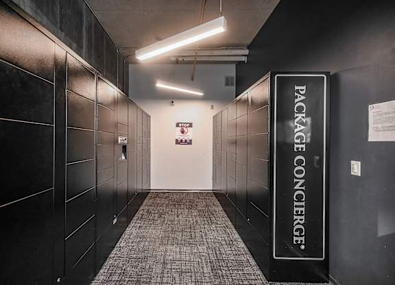 a hallway with black lockers and a welcome sign at Ninth Square Apartments, New Haven, CT, 06510