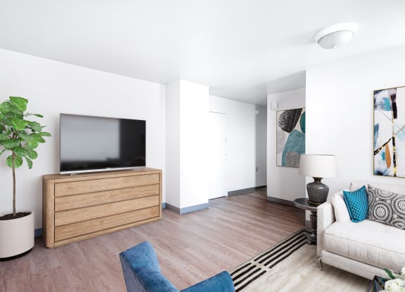 A living room with Furniture and TV and and hardwood flooring at Richford Arms Apartments, Erie Pennsylvania
