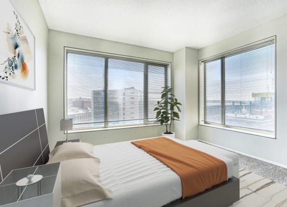 a bedroom with a bed and two windows