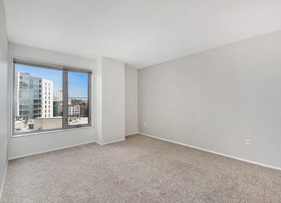 an empty living room with a large window