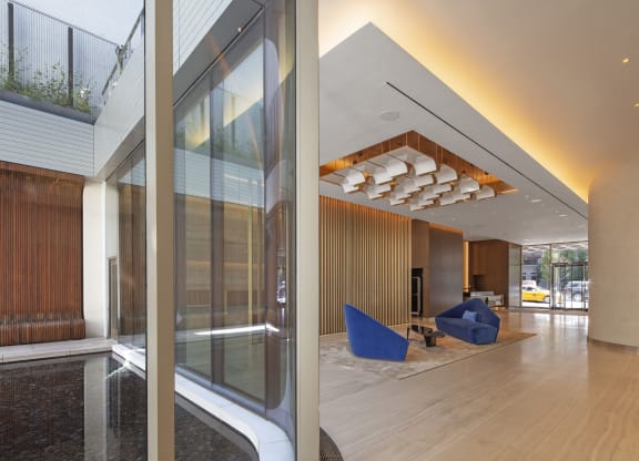 a large lobby with a blue chair in the middle of it