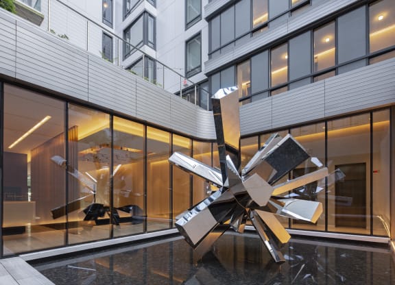 a large metal sculpture of a star in front of a building