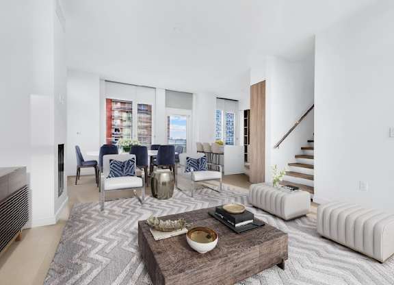 A modern living room with a wooden coffee table in the center.