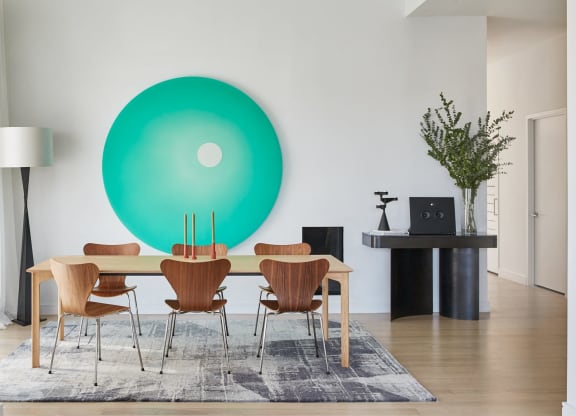 a large green circle on a wall in a dining room