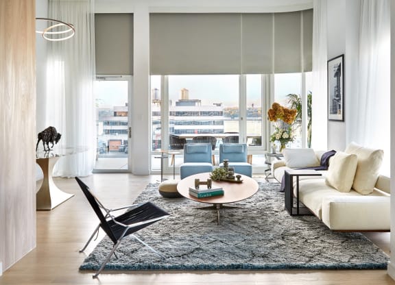 a living room with a white couch and a rug