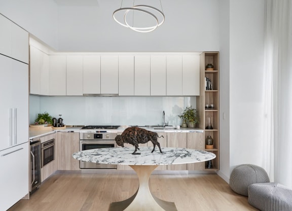 a kitchen with white cabinets and a table with a stag