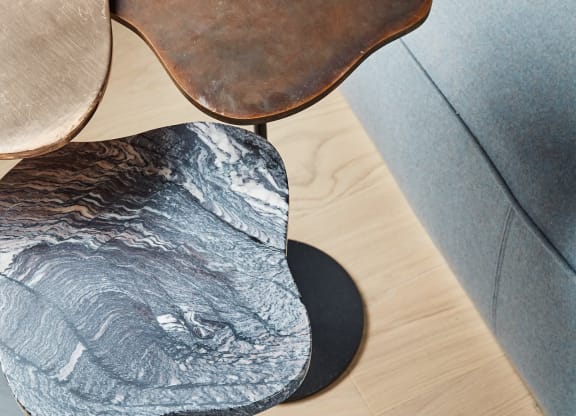 a close up of a chair with a base on a wooden table