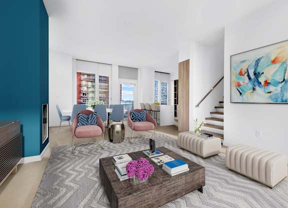 A living room with a brown coffee table and blue chairs.