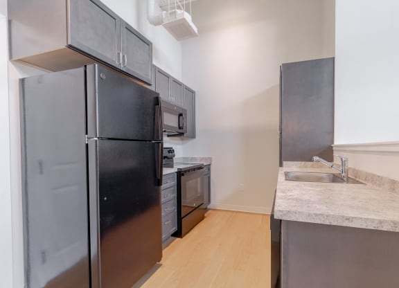 a kitchen with stainless steel appliances and a sink and refrigerator