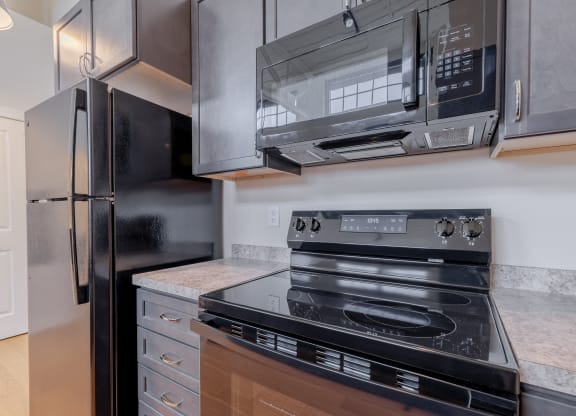 an updated kitchen with stainless steel appliances and a black stove