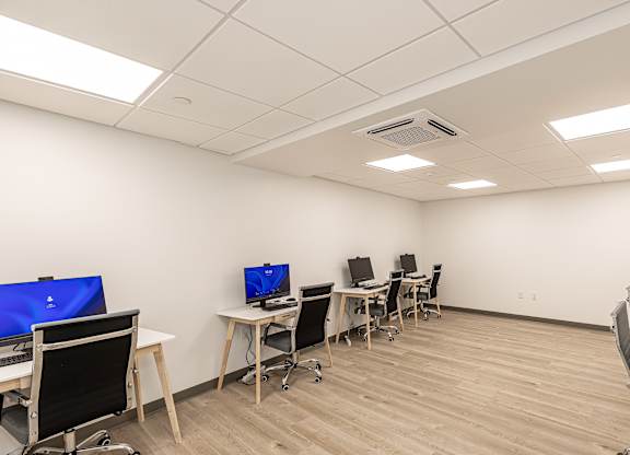 A room with multiple desks and computers.