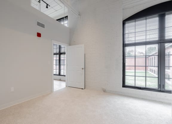 an empty room with a door and a window