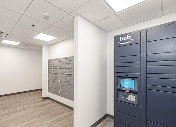 A room with a row of Amazon lockers on the right side.