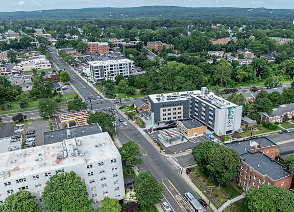 A city street with a large building on the right.