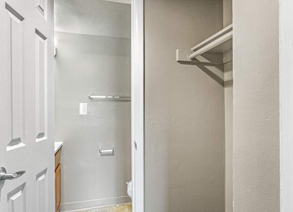 A white door is open to a hallway.
