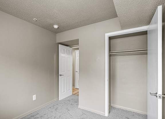 A room with a white door and a white wall.