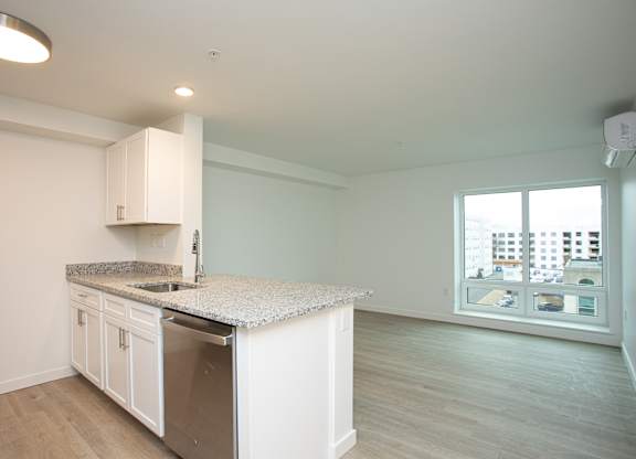 A kitchen with white cabinets and a granite countertop.at The Camelot, Connecticut  