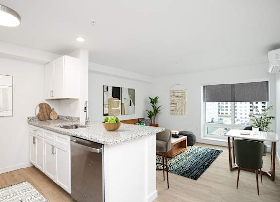 A modern kitchen with white cabinets and a large island.