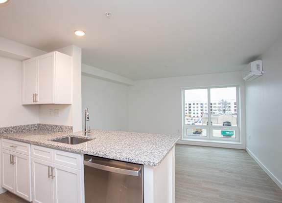 A kitchen with white cabinets and a granite countertop.at The Camelot, West Hartford, 06119  