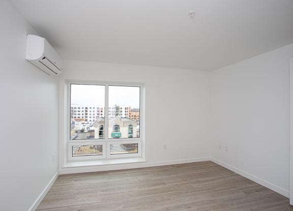 A room with a window overlooking a cityscape.at The Camelot, West Hartford  