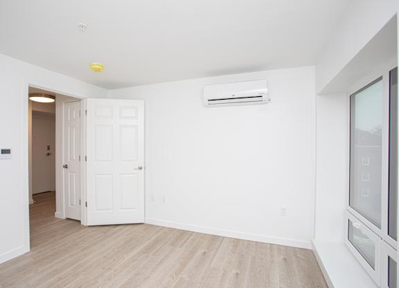 A room with a white door and a window with blinds.at The Camelot, West Hartford Connecticut  