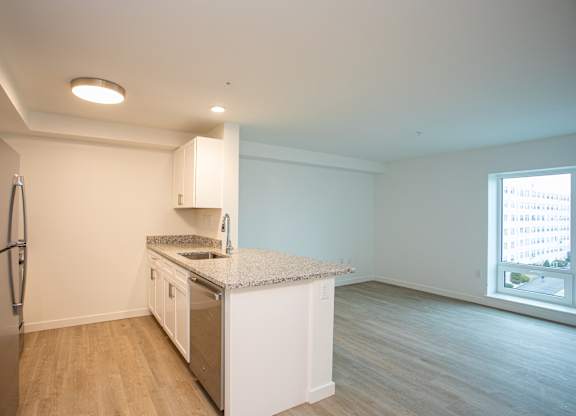 A kitchen with a refrigerator, sink, and countertop.at The Camelot, West Hartford, 06119  