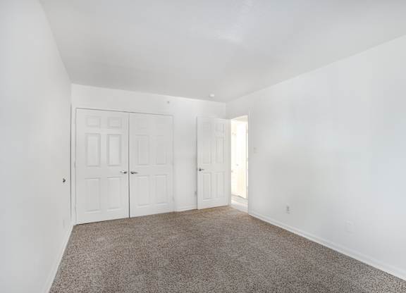 A room with white walls and a carpeted floor.