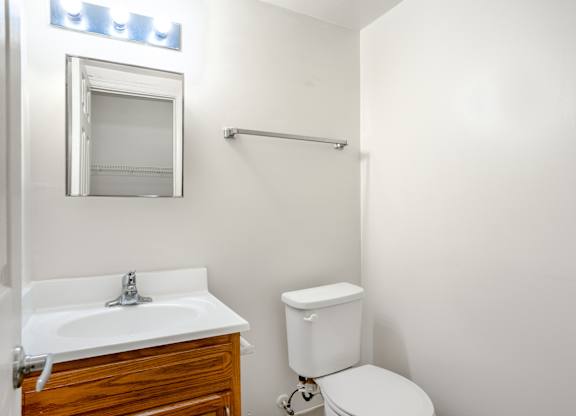 A white sink with a wooden drawer underneath it.