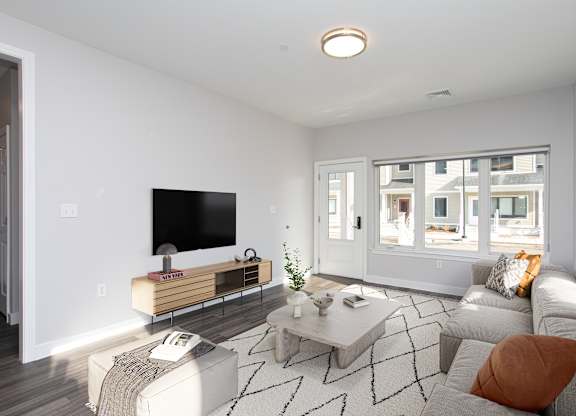 A modern living room with a flat screen TV and a coffee table at MLK Apartments, Hartford, 06106
