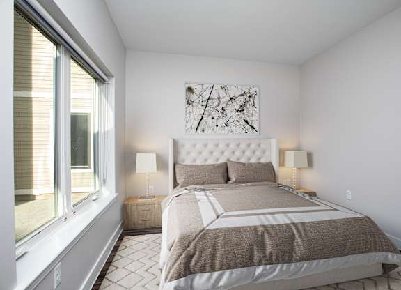 A bedroom with a large bed and a painting on the wall at MLK Apartments, Hartford, 06106