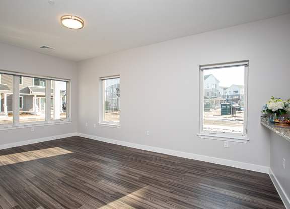 A room with wooden flooring and a window showing a view of a street at MLK Apartments, Hartford, 06106
