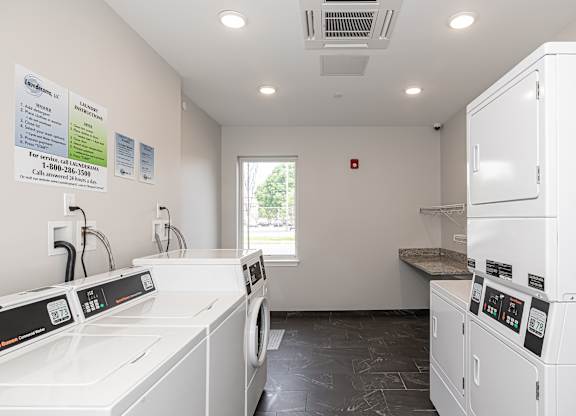 A laundry room with washers and dryers.