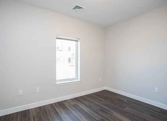 A room with a window and wooden flooring at MLK Apartments, Hartford, 06106