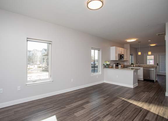 A kitchen with a white counter and brown flooring at MLK Apartments, Hartford, 06106