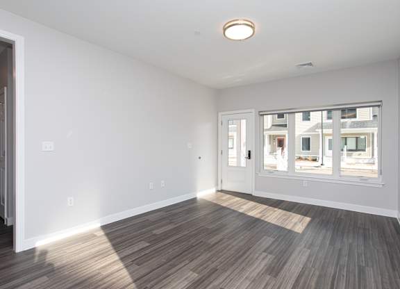 A room with a window and a wooden floor at MLK Apartments, Hartford, 06106