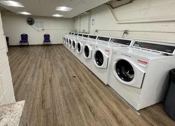 A laundromat with rows of washers and dryers.