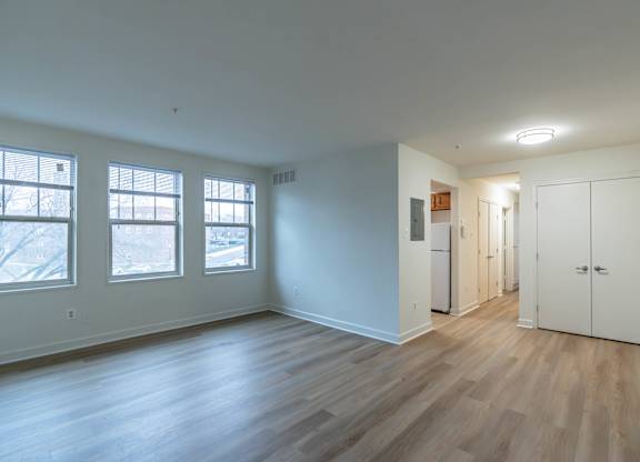 A room with wooden floors and white walls.