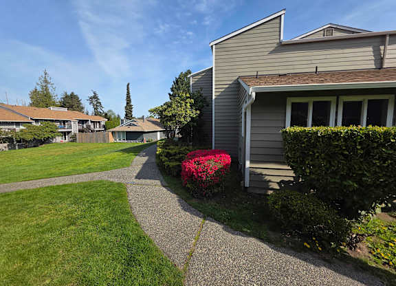 A residential area with houses and a clear sky.