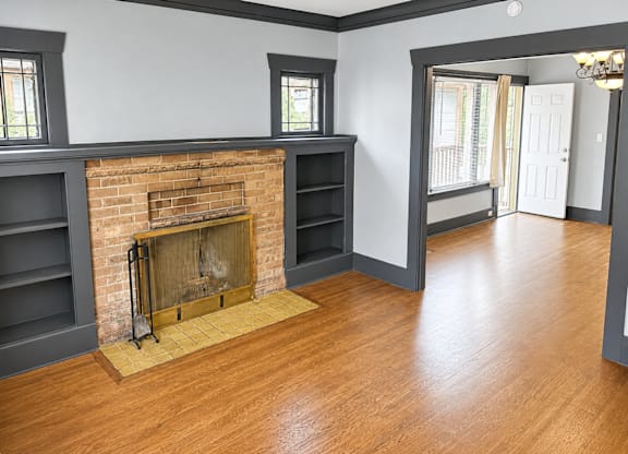 Living Room with a fireplace and a wooden floor.