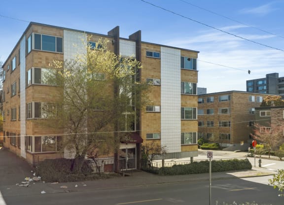 an apartment building on the corner of a city street